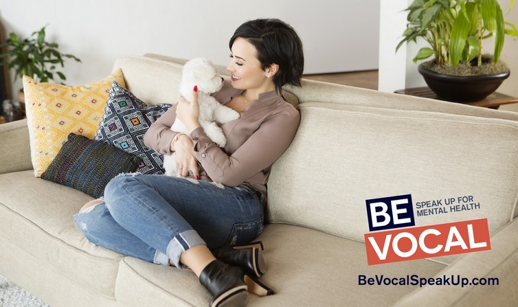 Be_Vocal_D._Lovato_on_couch_w_dog_Buddy_w_logo_Source-Isaac_Sterling