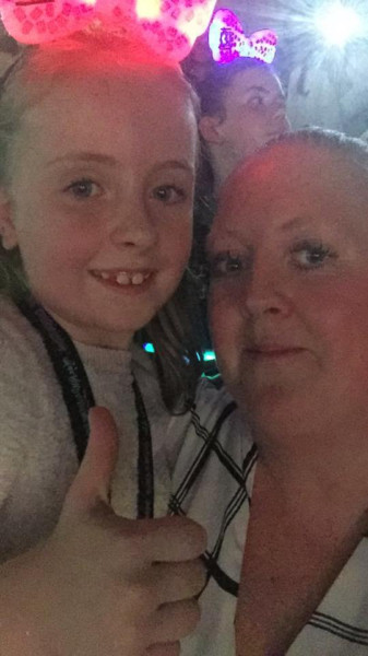 Lacey with her  mum at the concert - wide awake  this time!