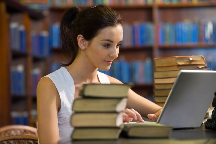 College Student Studying in Library --- Image by © Peter M. Fisher/Corbis