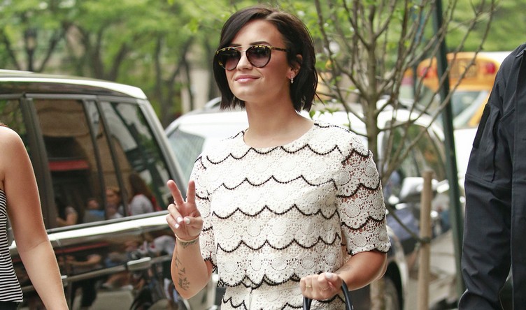 Demi Lovato waves the peace sign while on a stroll in New York City