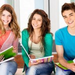 two-girls-and-one-boy-student-smiling-with-notebooks