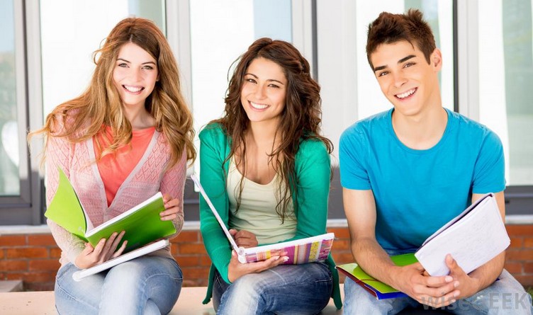 two-girls-and-one-boy-student-smiling-with-notebooks